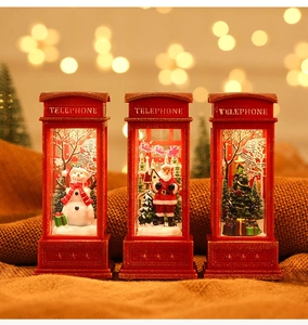 Close-up of lighted Christmas telephone booths with Santa and snowman figurines