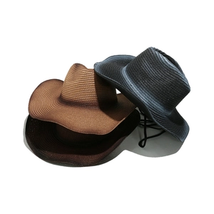 Straw Panama cowboy hats in brown and black with woven texture and wind rope for summer sun