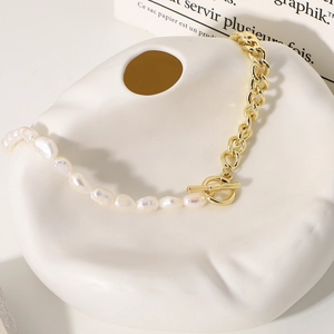 Detail of vintage 14k gold plated cuban link necklace with baroque pearls and OT clasp