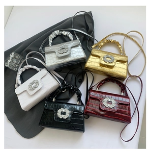 Détail de sacs à motif crocodile avec boucles en strass en cinq couleurs différentes