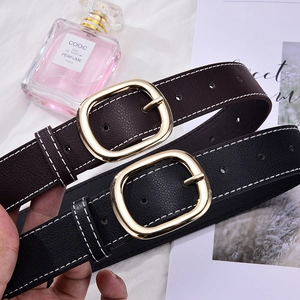 Women's thin leather belt in black and dark brown with gold buckle and white stitching