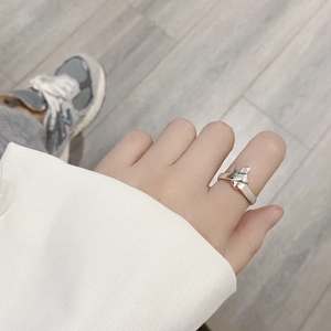 Minimalist 925 sterling silver bow knot ring on hand with a natural lifestyle background
