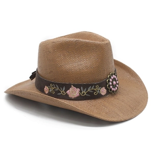 Detail of western straw hat featuring floral rose embroidery and vintage metal flower bead