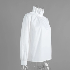 Detail of elegant white high pie-crust collar and pleated texture on long sleeve shirt