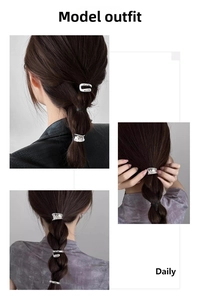 Close-up of silver metal ponytail cuffs with hammered texture on a low ponytail hair