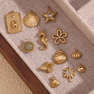 14K gold plated stainless steel ocean charms collection with starfish and seashell designs