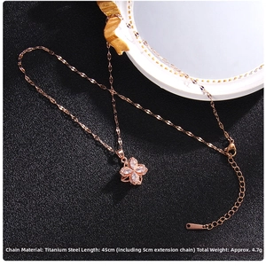 Macro shot of rose gold titanium steel spinning clover necklace with zircon crystals