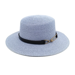 Detail of lavender straw flat top hat featuring a black leather band and gold buckle