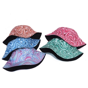 Detail of five colorful tie-dye bucket hats with reversible black inner lining