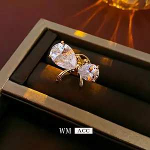 Exquisite gold-plated butterfly brooch featuring pear-cut zircon crystals on a jewelry box