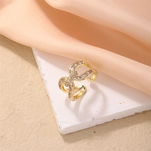Detailed view of an adjustable gold buckle ring with baguette cubic zirconia on silk