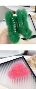 Detail view of pink and green rabbit fur claw clips showing soft texture and premium materials