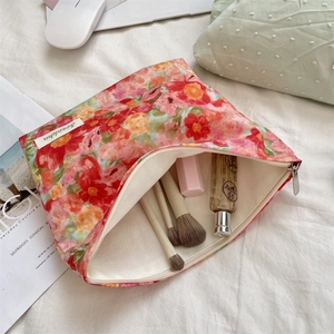 Detail view of the floral makeup bag interior showing spacious capacity and fabric lining