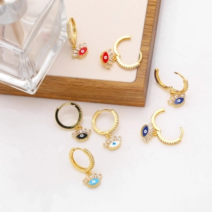 Detail of colorful Evil Eye earrings with zircon stones and gold-plated hoops