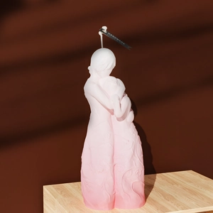 Detail of mother and child candle with pink gradient and floral relief texture