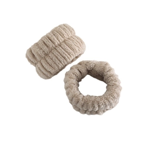 Close-up of soft khaki plush scrunchies showing fuzzy texture and ribbed knit details