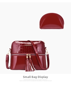 Detail view of burgundy croc-embossed large tote and matching semi-circle clutch set
