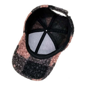 Detailed interior of teddy fleece baseball cap with pink and grey patchwork design