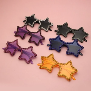 Detail of star-shaped rimless sunglasses in candy colors with sparkling rhinestone edges