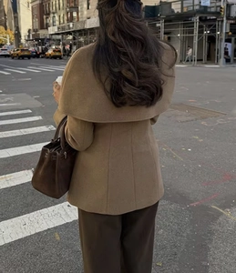 Back view of a brown wool coat featuring a large cape collar and slim fit tailoring
