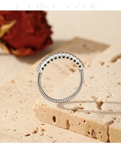 Macro shot of S925 silver ring featuring spiral texture and row of sparkling cubic zirconia