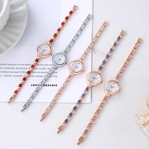 Flat lay of quartz watches with crystal bracelets in gold and silver metal finishes