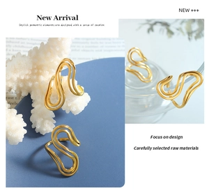 Detailed views of polished gold S-curve rings displayed on elegant props for women