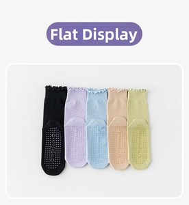 Detail view of five pairs of yoga socks with silicone grips and lettuce edge cuffs