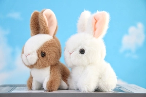 Close-up of brown and white plush rabbit keychains with soft faux fur and cute features