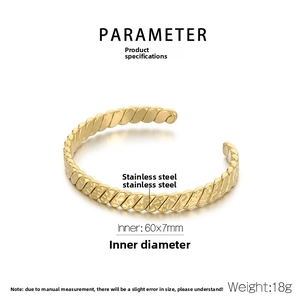 Detailed view of gold twisted rope bangle with 60x7mm dimensions and stainless steel texture