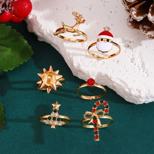 Close-up of 6-piece Christmas ring set with reindeer and tree motifs on stone