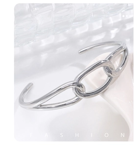 Detailed macro shot of a silver chain-link stainless steel bangle with polished finish