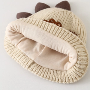Détail du bonnet en tricot pour bébé montrant la laine épaisse et la doublure douce