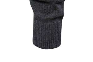 Close-up of dark grey men's knit cardigan showing detailed ribbed cuffs and texture