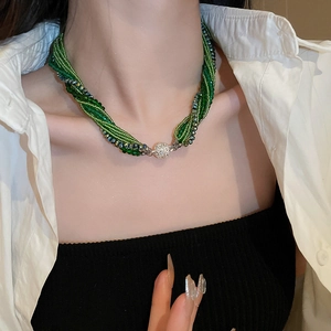 Detail of multi-layer green beaded necklace with sparkling crystal magnetic clasp