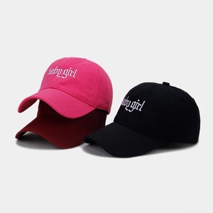 Three cotton baseball caps with Babygirl embroidery in pink, burgundy, and black