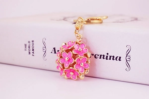 Detail of pink floral bouquet keychain with gold metal base and lobster clasp