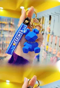 Blue geometric resin bear keychain with silicone wrist strap and gold metal hardware