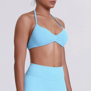 Detail of light blue high-stretch seamless ribbed fabric on halter neck sports bra