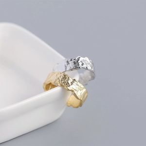 Close-up of S925 sterling silver rings with gold and silver irregular foil textures