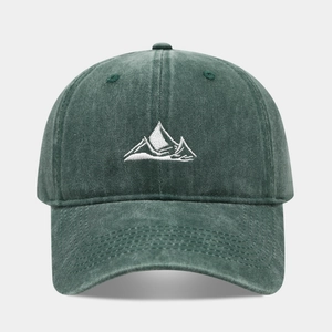 Detailed embroidery of white mountain peaks on dark green washed cotton baseball cap