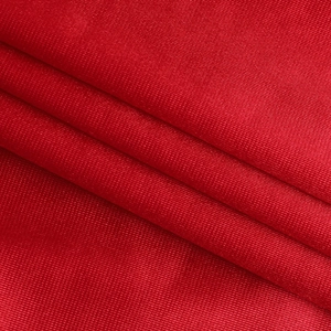 Close-up of elegant red evening dress fabric showing fine knitted mesh and texture