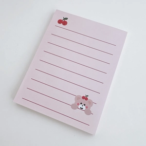 Detail of pink notepad featuring cute bear and cherry motifs with lined pages