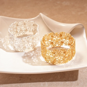 Matte hollow floral cuff bracelet set in gold and silver finish with geometric patterns