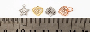 Macro shot of 10mm star and heart pendants with white zircon in gold, silver, and rose gold