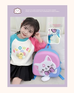 Close-up of cute cartoon cat backpack featuring a squeeze-to-sound interactive feature