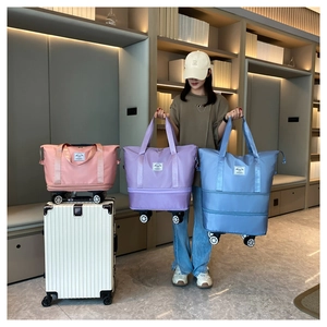 Detailed comparison of pink, purple, and blue expandable travel bags with spinner wheels