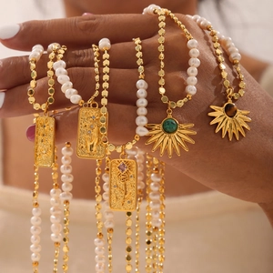 Bohemian gold freshwater pearl necklace set with vintage embossed charms and turquoise