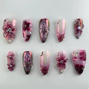 3D embossed floral press-on nails with dark purple aurora finish and crystal accents