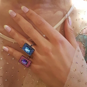 Close-up of square blue and purple gemstone rings with full diamond micro-pave setting